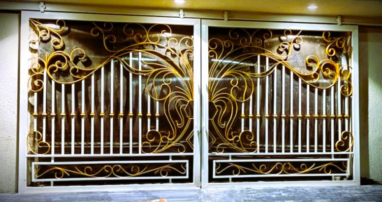 Custom residential gate with a unique geometric pattern and black finish.